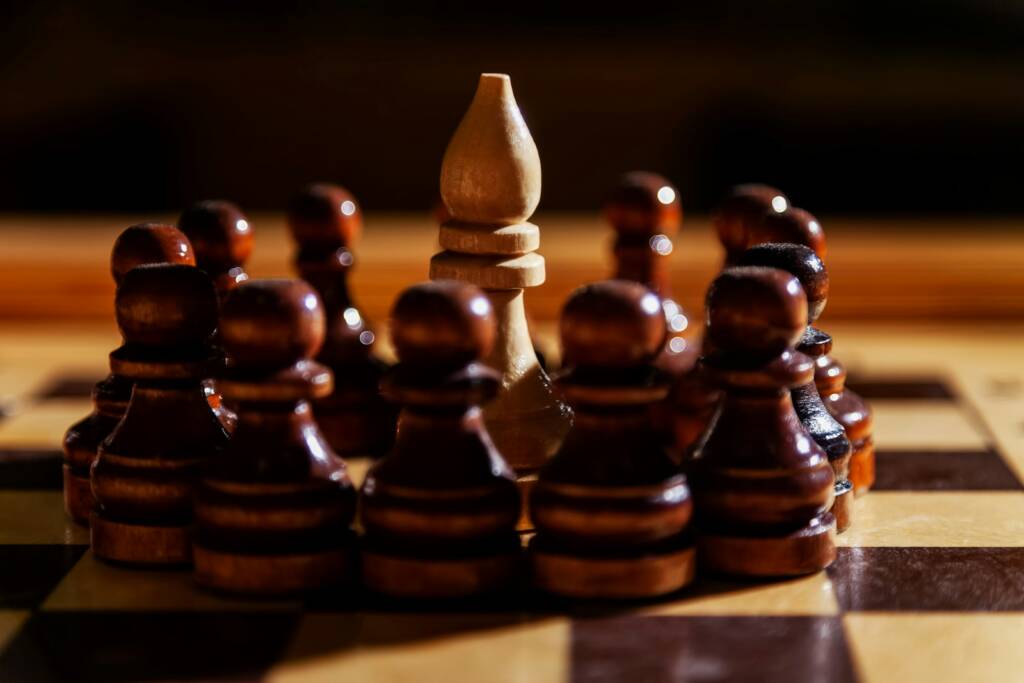 A bishop is surrounded by pawns on a chessboard.