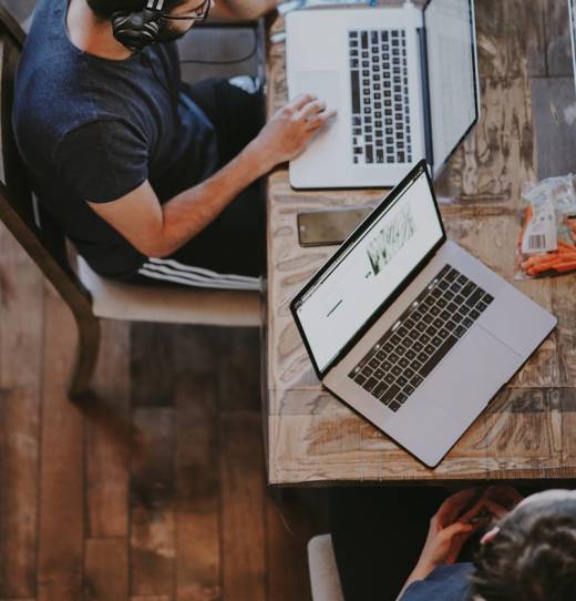 man sitting on chair and looking laptop computer